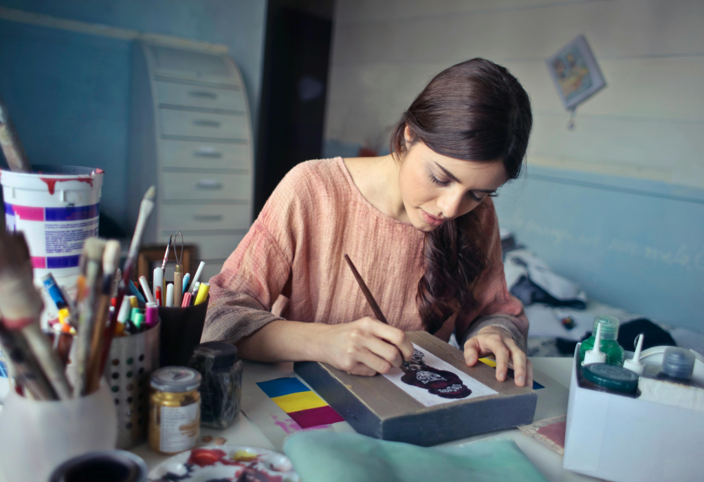 A woman Unleashing creativity through the act of painting.